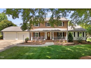 Charming brick home with a welcoming front porch and well-manicured lawn at 2127 Somers Ave, Burlington, NC 27215