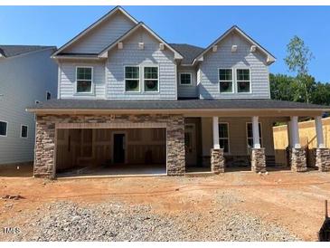 Craftsman-style home featuring stone accents and a welcoming covered porch, blending elegance with modern design at 444 Golden Dragonfly St, Wake Forest, NC 27587