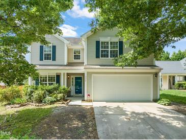 Two-story home with a two-car garage, blue shutters, and landscaped front yard at 5312 Suntan Lake Dr, Raleigh, NC 27610