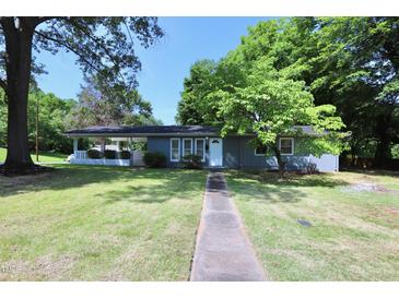 Charming single story home with a well-maintained lawn and mature trees at 722 Orchard Dr, Graham, NC 27253