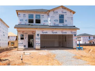 A two-story home in the early stages of construction showcasing its Tyvek-protected exterior at 824 Ottawa Dr, Garner, NC 27529