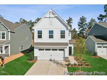 New construction home showcasing a white facade and two-car garage at 92 Horseshoe Pl # 9, Angier, NC 27501