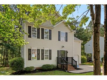 Charming two-story home with black shutters, landscaped yard, and a welcoming front porch at 112 Fairford Dr, Holly Springs, NC 27540