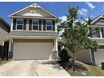 Two story home with attached two car garage, and landscaping on a clear day at 133 Explorer Dr # 258, Morrisville, NC 27560