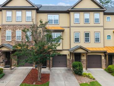 Inviting townhome exterior with a well-maintained lawn and tasteful landscaping showcasing the architecture at 2609 Stewart Pines Dr, Raleigh, NC 27615