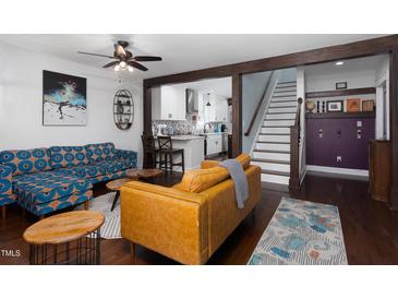 Open-concept living room showing the bright decor and stairs leading to the second floor at 2805 Fayetteville St, Durham, NC 27707