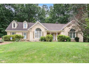 Charming brick home featuring manicured lawn and mature trees in a desirable neighborhood at 3 Bent Oak Ct, Durham, NC 27705