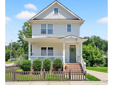 Charming two-story home featuring a welcoming front porch, well-manicured landscaping, and a classic architectural style at 309 S Haywood St St, Raleigh, NC 27601