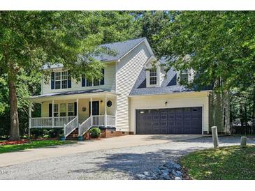 Charming two-story home with a welcoming front porch and attached two-car garage at 353 Spearhead Pl, Clayton, NC 27520