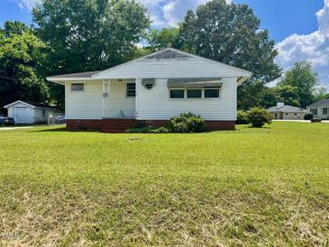 Charming single-story home with white siding and a well-maintained front lawn at 508 E Mcneill St, Lillington, NC 27546