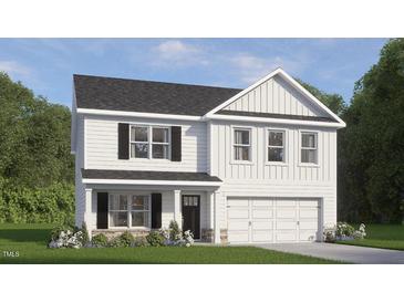 Charming two-story home with classic design, black shutters and a manicured lawn in a desirable neighborhood at 705 Comice Pear Way, Willow Springs, NC 27592