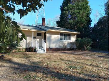 Quaint one-story home with a welcoming front porch and mature shade trees at 912 Dixie Trl, Raleigh, NC 27607