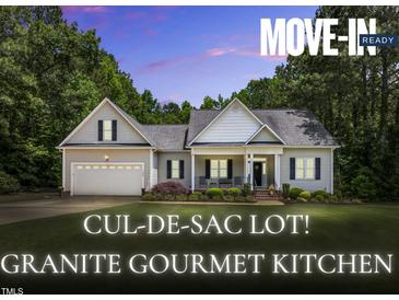 Charming single-story home featuring a two-car garage and beautifully landscaped front yard in a cul-de-sac setting at 123 Holiday Island Dr, Garner, NC 27529