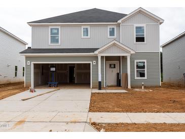 Under construction, two-story home boasts a two-car garage, neutral siding, and a modern design at 2242 Cherry Creek Rd, Haw River, NC 27258