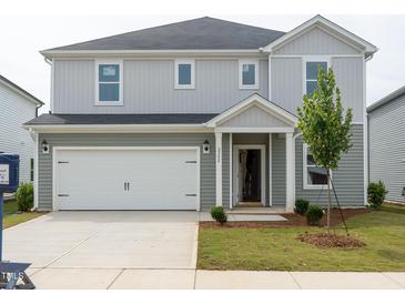 Charming two-story home with a two-car garage and landscaped front yard at 2242 Cherry Creek Rd, Haw River, NC 27258
