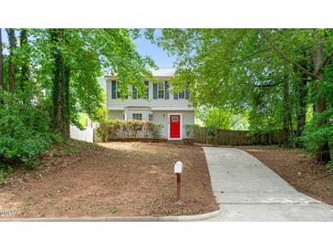 Charming two-story home featuring a bright red front door, blue shutters, and a well-manicured front yard at 2309 Hoot Owl Ct, Raleigh, NC 27603