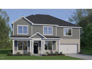 Charming two-story home featuring a covered front porch and a two-car garage at 2341 Horton Park Dr, Apex, NC 27539