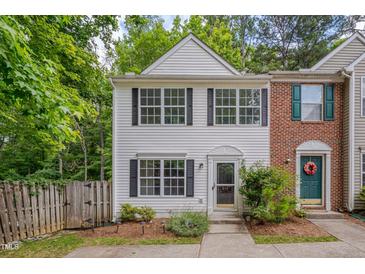 Charming two-story townhouse with white siding, black shutters, and a well-maintained front yard at 314 Virens Dr, Cary, NC 27511