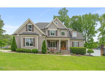Charming two-story home with a manicured lawn and beautiful landscaping, creating a welcoming curb appeal at 5308 Montclair Dr, Raleigh, NC 27609