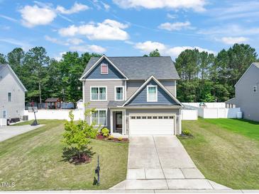 Charming two-story home featuring a well-manicured lawn, lovely curb appeal, and an attached two-car garage at 5412 Emerald Spring Dr, Knightdale, NC 27545