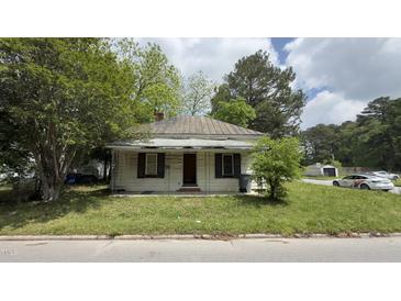 Quaint single-story home with a metal roof and covered front porch, needs work at 752 Nashville Rd, Rocky Mount, NC 27803