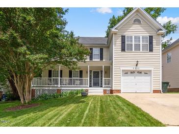 Charming two-story home featuring a welcoming front porch and well-manicured lawn at 9212 Sayornis Ct, Raleigh, NC 27615