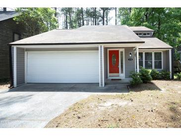 Charming one-story home with a bright red front door and attached garage at 1110 Elmira Ave, Durham, NC 27707