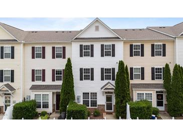 Charming townhouse featuring a white facade, black shutters and well-maintained landscaping at 1120 Renewal Pl # 111, Raleigh, NC 27603