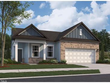 Charming exterior elevation of a two-story home with a brick and siding facade and an attached garage at 124 N Keatts Winner Ct, Wilson's Mills, NC 27520