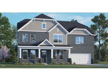Charming two-story home with a covered front porch, brick facade, and attached two-car garage at 141 Pony Gallop Ln, Clayton, NC 27520