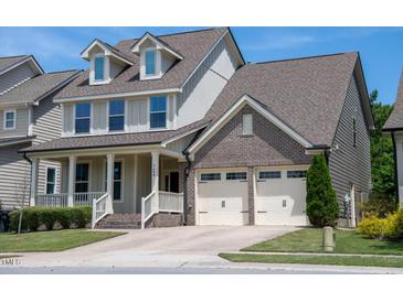 Charming two-story home with a welcoming front porch and a two-car garage at 1600 Drift Falls Ln, Wendell, NC 27591