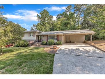 Charming home featuring a carport and a lush green lawn at 1920 Hillock Dr, Raleigh, NC 27612