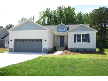 Charming single-story home with a gray two-car garage, blue shutters, and a well-manicured lawn at 235 Eason Creek Way, Clayton, NC 27527