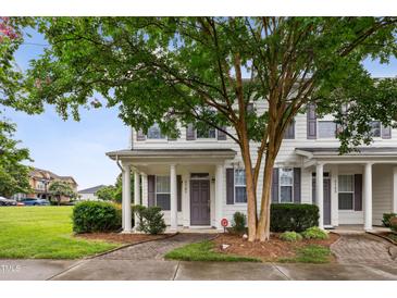 Charming townhome with well-maintained landscaping, inviting entrance, and front porch at 3141 Rapid Falls Rd, Cary, NC 27519