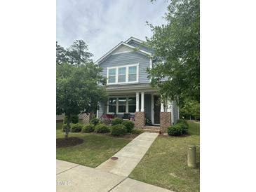 Charming two-story home with blue siding, brick accents, and a welcoming front porch at 425 Liberty Hill, Morrisville, NC 27560