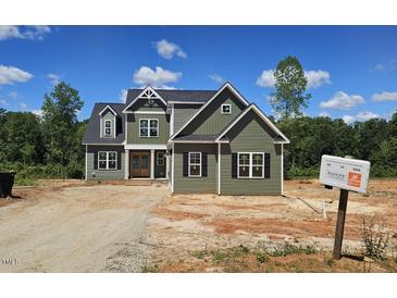 Inviting two-story home with vertical siding, black shutters, and symmetrical design at 55 Livingston Ln, Spring Hope, NC 27882
