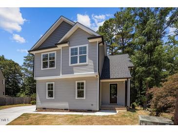 Charming two-story home with gray siding, modern windows, and a well-maintained landscape at 5601 Preston Pl, Raleigh, NC 27604