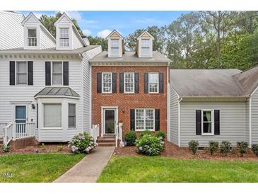Charming brick townhome with manicured lawn and inviting walkway at 6032 Epping Forest Dr, Raleigh, NC 27613