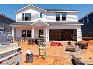 New construction of a two-story home with a large two-car garage in the process of being completed at 740 Deschutes Dr, Garner, NC 27529