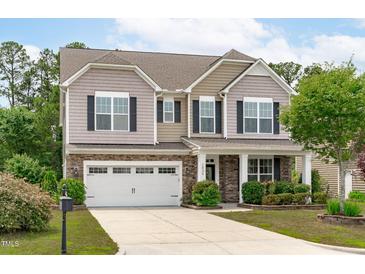 Charming two-story home with stone accents, a well-manicured lawn, and a two-car garage at 1024 Holland Bend Dr Dr, Cary, NC 27519