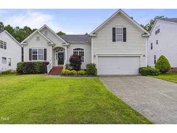 Charming home featuring a well-manicured lawn, two-car garage, and beautiful landscaping at 107 Governors House Dr, Morrisville, NC 27560