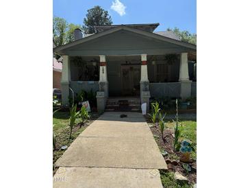 Charming exterior view of a two-story home with a front porch and walkway at 109 N 2Nd St, Sanford, NC 27330