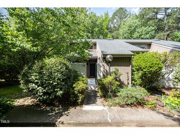 Inviting front entrance with lush landscaping and a well-maintained walkway leading to the front door at 16 Tottenham Ln # 16, Chapel Hill, NC 27517