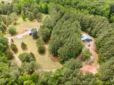 Expansive aerial view of wooded property with home and outbuilding at 197 Country Routt Brown Rd, Pittsboro, NC 27312