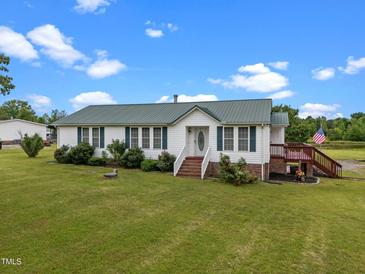Charming single-story home featuring green shutters, mature landscaping, and a welcoming front lawn at 1993 Lucy Garrett Rd, Roxboro, NC 27574
