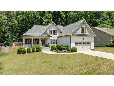 Charming single-Gathering home with a landscaped front yard and welcoming two-car garage at 230 Paddy Ln, Youngsville, NC 27596