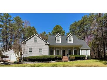 Charming two-story home with manicured lawn, covered porch, and attached garage at 2934 Appaloosa Ct, Graham, NC 27253