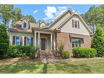Charming home featuring a stone facade, landscaped front yard, and inviting front porch at 344 Colonial Ridge Dr, Pittsboro, NC 27312