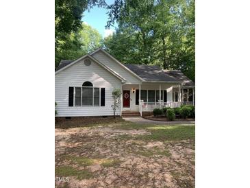Charming single-story home featuring a red front door and covered porch at 352 Riverstone Dr, Clayton, NC 27527