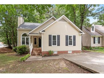 Charming single-Gathering home featuring a brick foundation, neutral siding, and classic black shutters at 4401 Liverpool Ln, Raleigh, NC 27604